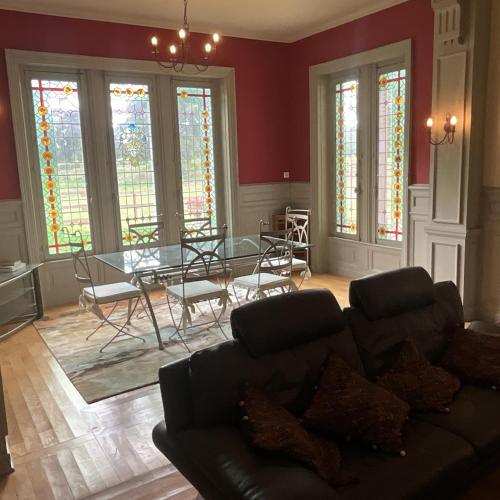 a living room with a couch and a table at Chateau Tout Y Fault in Loriges