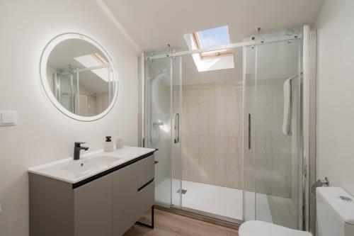 une salle de bains avec douche, lavabo et miroir dans l'établissement Fort of Old Town Apartments by OurMadeira, à Funchal