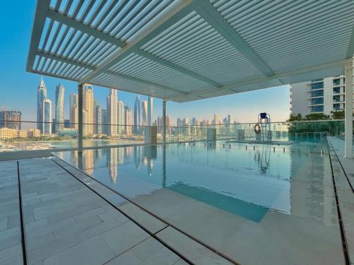 a swimming pool with a view of the city at Seaside Lux Retreat 2-BR Private Beach in Dubai