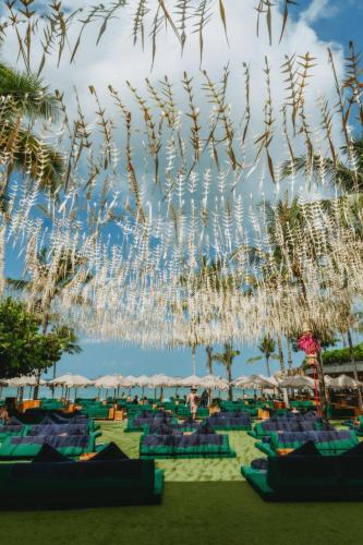 a view of a beach with chairs and umbrellas at Potato Head Suites & Studios in Seminyak