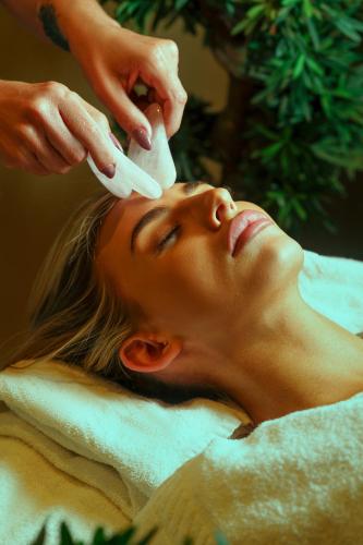 a woman getting her hair washed at a salon at Park hall Hotel & Spa Lancashire, a member of Radisson Individuals in Eccleston