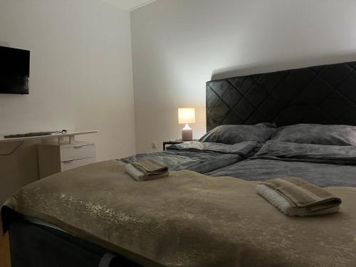 a bedroom with a bed with two towels on it at GuestHouse Marko Belišće in Belišće