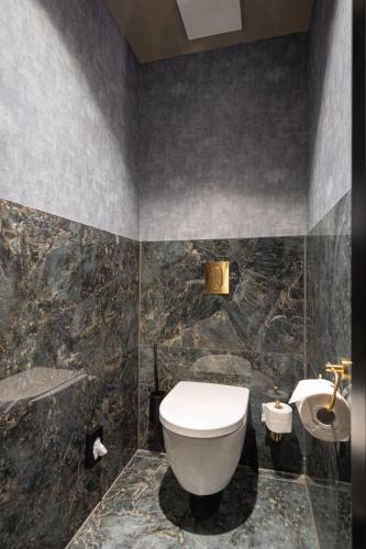 a bathroom with a toilet and a sink at AMIA Hotel Singen in Singen