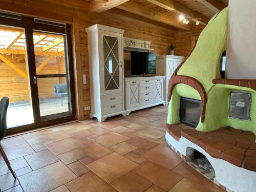 a living room with a tv and a room with a kitchen at Gästehaus Carpe Diem in Kappel-Grafenhausen