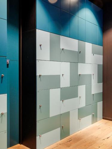 a wall of drawers in a room at KONCEPT HOTEL International in Cologne