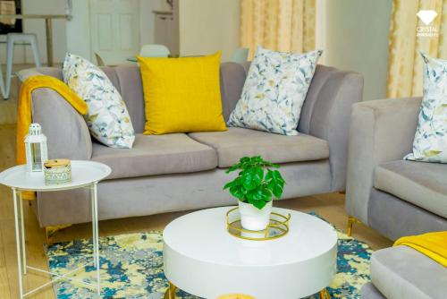 a living room with a couch and a table at Sunset Bliss Paradise in Lilongwe in Lilongwe