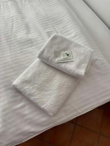 a napkin sitting on top of a white bed at Vila Dora B&B in Požega