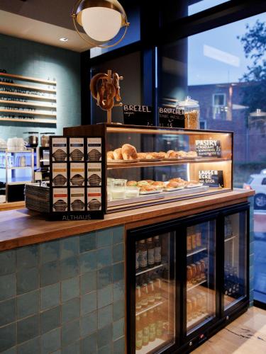 a bakery counter with a lot of pastries on display at KONCEPT HOTEL International in Cologne