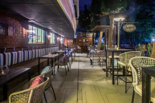 a restaurant with tables and chairs in a room at T24 Retro in Mumbai