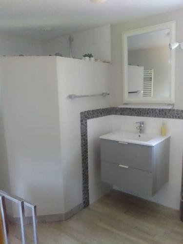 a white bathroom with a sink and a mirror at La grange de Manu in Richtolsheim
