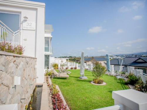 a view of a garden from the balcony of a house at Beautiful Gate in George