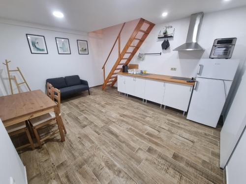 a kitchen and dining room with a refrigerator and a table at G3 Gamboa Beach Houses in Peniche