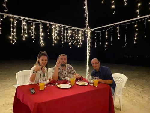 a group of people sitting at a table with drinks at Rindali - The speedboat from Malé to the hotel departs at 1130 every Monday Thursday and Saturday and from the hotel to Malé at 0630 and five domestic flights are available every day in Dhaalu Atoll