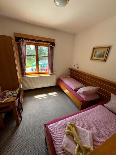a bedroom with two beds and a window at bouda Pod Sněžkou in Pec pod Sněžkou