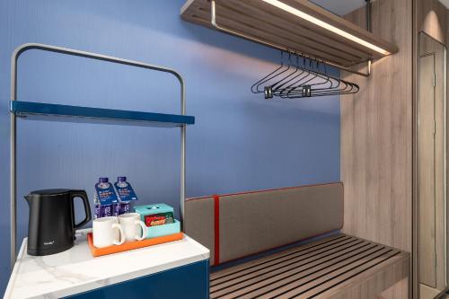 a room with a counter with water bottles on it at Holiday Inn Express Qingdao Hongdao Station by IHG - Qingdao International Airport in Qingdao