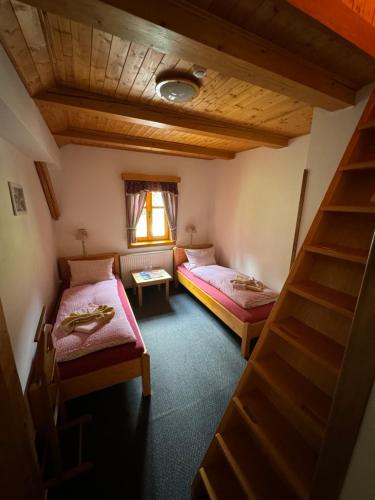 a room with two beds and a staircase in it at bouda Pod Sněžkou in Pec pod Sněžkou