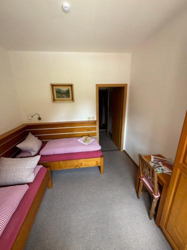 a room with two beds and a table at bouda Pod Sněžkou in Pec pod Sněžkou