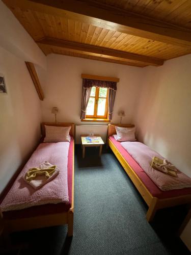 a room with two beds and a window at bouda Pod Sněžkou in Pec pod Sněžkou