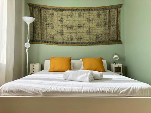 - un lit blanc avec des oreillers orange dans une chambre dans l'établissement 2FOR - Terrace full sky in Marseille, à Marseille