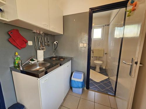 a small bathroom with a sink and a shower at Apartment Magdica in Malinska