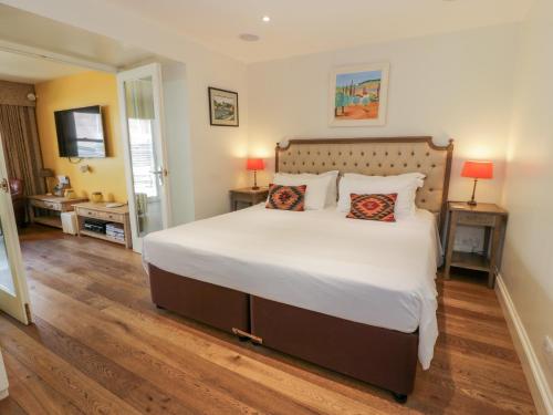 a bedroom with a large white bed with two pillows at The Suite in Thornhill