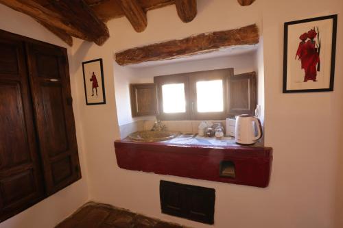 a bathroom with a sink and a window at Casalar in Alhama de Granada