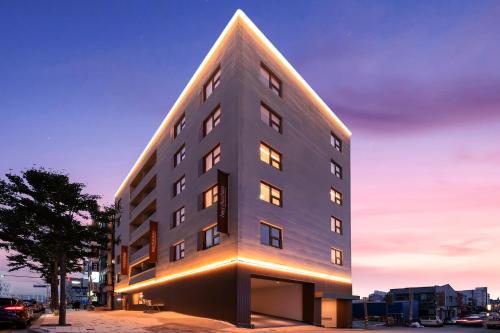a tall building with a triangle shaped roof at Chuncheon Hey Hotel in Chuncheon