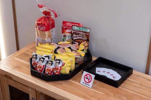 a table with two boxes of chips and other snacks at Pillow BKK Bliss townhome 5BR,7TL near BTS&MRT QSCC in Khlong Toei