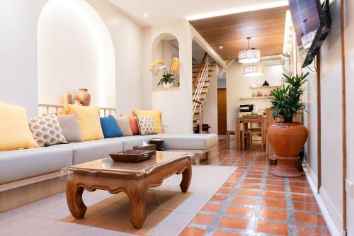 a living room with a couch and a table at Pillow BKK Bliss townhome 5BR,7TL near BTS&MRT QSCC in Khlong Toei