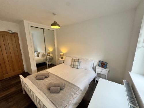 a bedroom with a bed with two towels on it at Inchconnachan Apartment in Bonhill