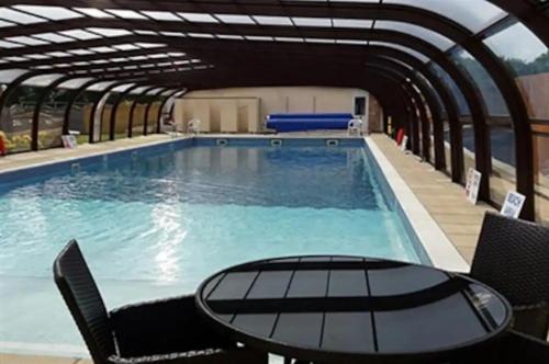 a large swimming pool with a table and chairs at Coastal Retreat at Waterside Park in Corton