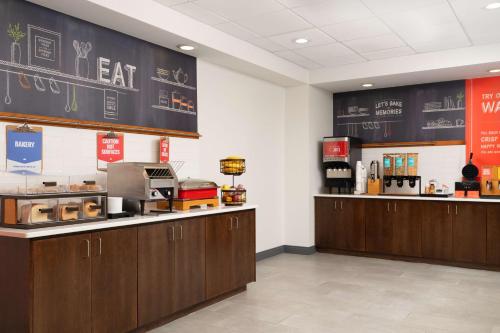 a fast food restaurant with wooden cabinets and a chalkboard at Hampton Inn Spring Lake Fayetteville in Spring Lake