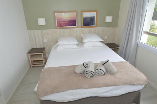 una camera con due letti e asciugamani sul letto di Maison Normandy Garden a Danestal