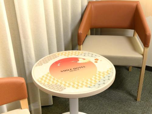 a chair with a plate on the back of it at Smile Hotel Premium Kanazawa Higashiguchiekimae in Kanazawa