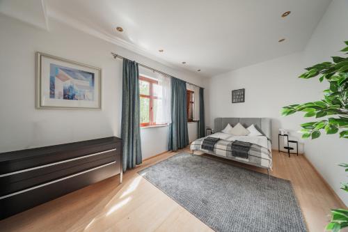 a bedroom with a bed and a large window at Bergblick Apartments in Innsbruck