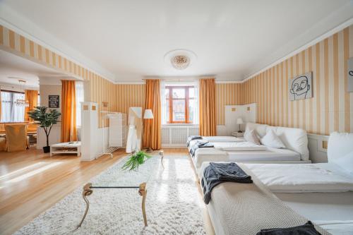 a room with three beds and a couch at Bergblick Apartments in Innsbruck