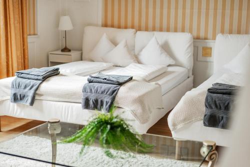 a living room with a white couch and a glass table at Bergblick Apartments in Innsbruck