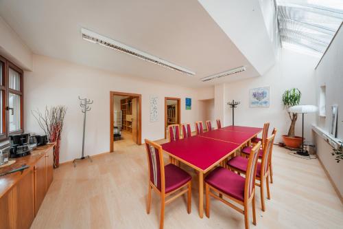 a dining room with a red table and chairs at Bergblick Apartments in Innsbruck