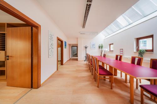 a long dining room with a long table and chairs at Bergblick Apartments in Innsbruck