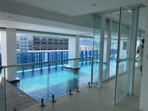 a large swimming pool in the middle of a building at 38 Park Avenue right in the heart of IT Park Cebu, 55 inches TV, wifi in Tabok