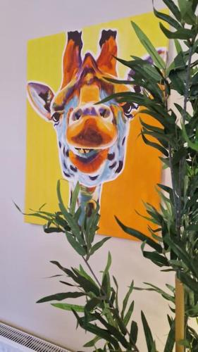 a painting of a giraffe on a wall at Benroe House 5 Bedrooms in Killybegs