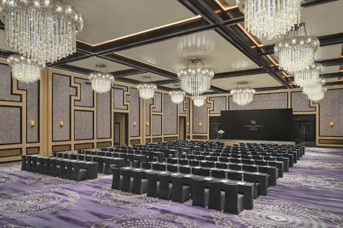 a large room with a stage and chandeliers at Waldorf Astoria Chengdu in Chengdu