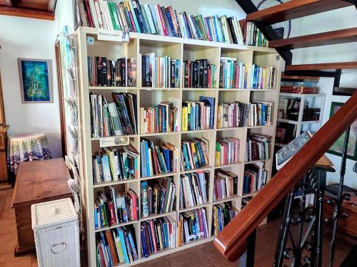 a book shelf filled with lots of books at Rivendell Eco lodge in El Paso