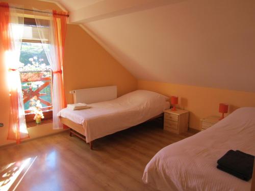 a bedroom with two beds and a window at Privat Vrbov 23 in Vrbov