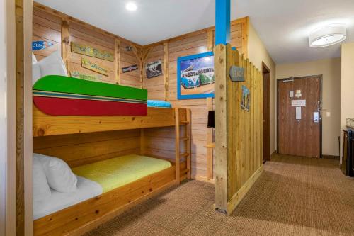 a room with two bunk beds with a boat on it at Comfort Inn Ludington near US-10 in Ludington