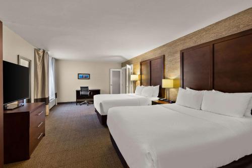 a hotel room with two beds and a television at Comfort Inn Ludington near US-10 in Ludington