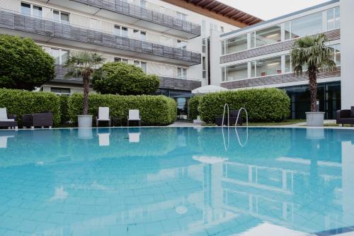 a swimming pool in front of a building at Spa Resort Geinberg in Geinberg