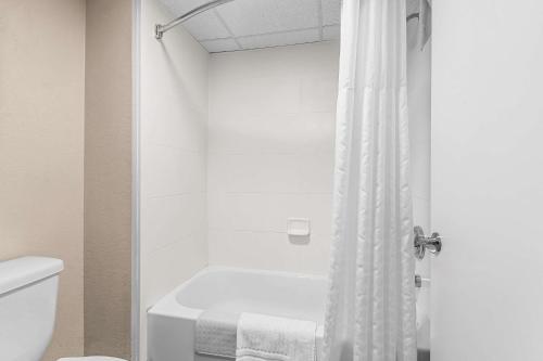 a bathroom with a tub and a toilet and a shower at Comfort Inn Clinton in Clinton