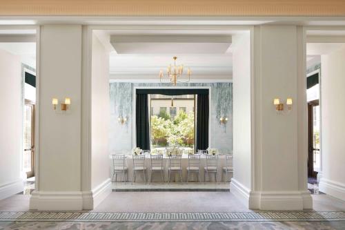 a dining room with columns and a mirror at Waldorf Astoria Atlanta Buckhead in Atlanta