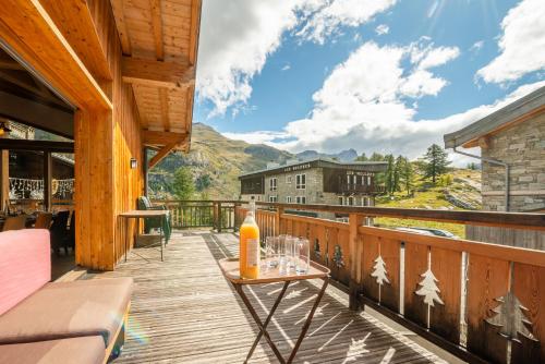 a balcony with a table with an orange bottle on it at Chalet Monte Bianco in Tignes